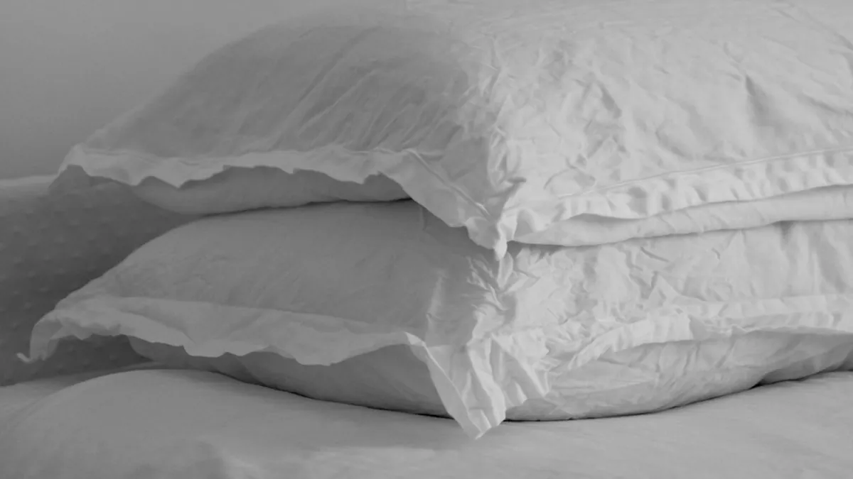 Request a blanket and pillow from flight attendants immediately after boarding to establish your sleep nest before cabin service begins